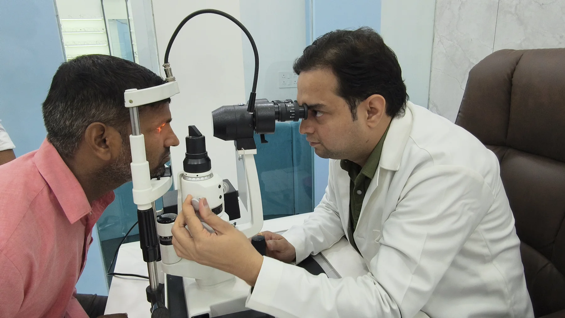 Doctor examining patient with slit lamp